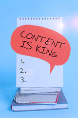 Writing note showing Content Is King. Business concept for believe that content is central to the success of a website Spiral notebook speech bubble stacked old books cool pastel background