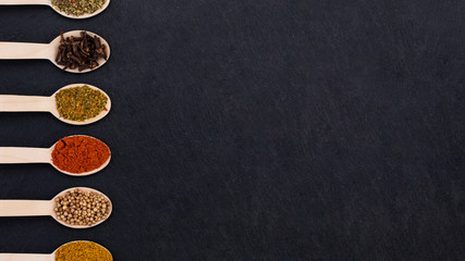 Various spices on dark background. Top view with copy space