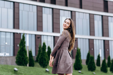 A young girl walks near the office with a handbag on her shoulder