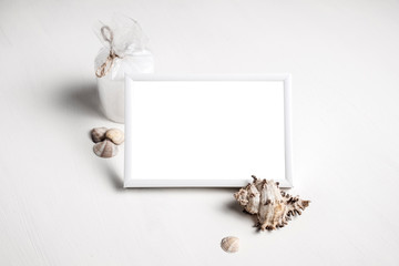 Photo frame with a white background decorated in a marine style.  White photo frame with a shell with a place for your photo