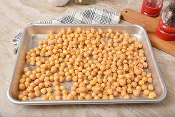 Uncooked garbanzo beans in a roasting pan