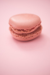 strawberry macarons on pink background, selective approach
