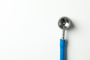 Blue stethoscope on white background, space for text