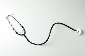Black stethoscope on white background, space for text