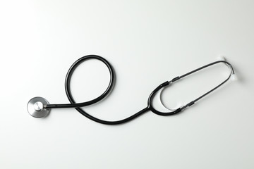 Black stethoscope on white background, space for text