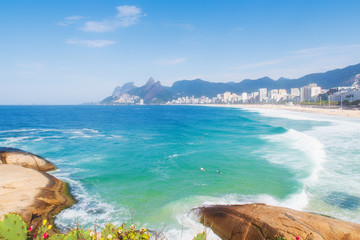 Seascape of Rio de Janeiro beaches depicting Arpoador beach and rocks with a green sea - 295185077
