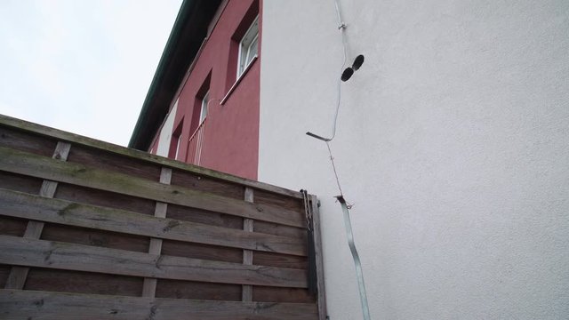 Useless lightning rod connected only with cooper wire 4K. Wide view of the lightning rod disconnected in-between and wired only by cooper wire.