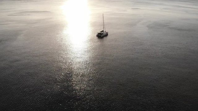 aerial view of a yacht anchored off a tropical island at sunset in Vanuatu, South Pacific