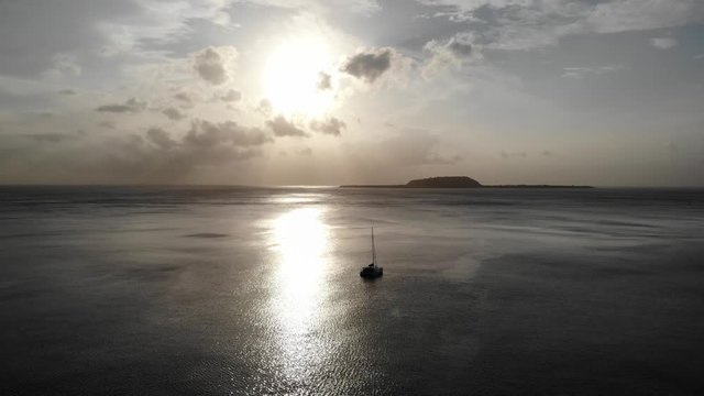 aerial view of a yacht anchored off a tropical island at sunset in Vanuatu, South Pacific