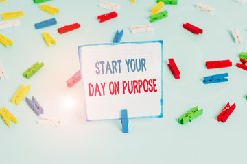Conceptual hand writing showing Start Your Day On Purpose. Concept meaning Have clean ideas of what you are going to do Colored clothespin papers empty reminder blue floor officepin
