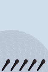 Beautiful black professional metal microphones on blue background.