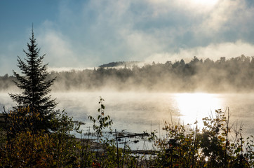 Fototapeta premium Early Morning Mist Over a Lake in Algonquin Park