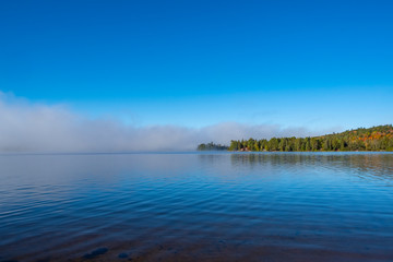 Morning Mist in Lake of Two Rivers in Algonquin Park, Ontario, Canada