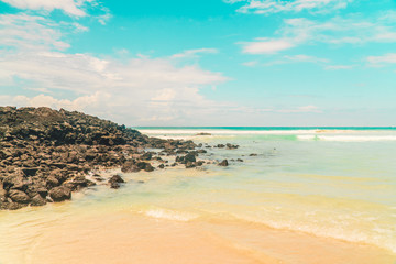Tropical beach with turquoise ocean waves and white sand. Holiday, vacation, paradise, summer vibes. Shot in Tortuga Bay, San Cristobal, Galapagos Islands.