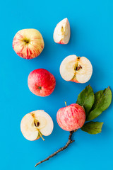 Autumn composition with fresh apples on blue background top view