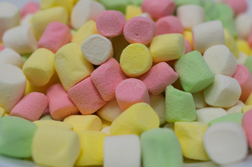 A pile of colorful sweet marshmallow candies.