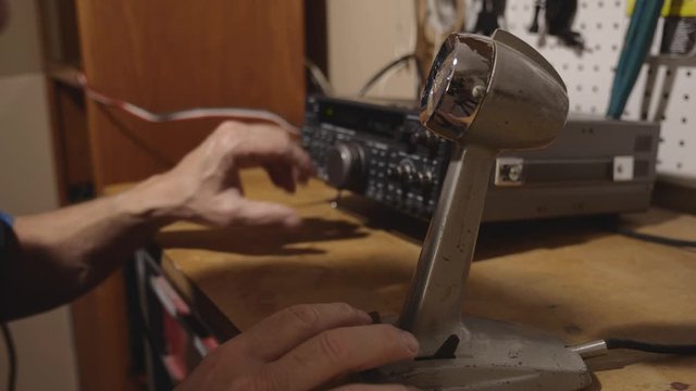 A man talking into a microphone on a shortwave radio