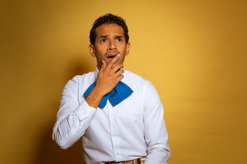 Charro Mexican young man dressed in typical custom Mariachi White Blue Yellow