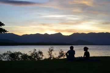 People sitting watching the sunset in Port Douglas in North Queensland Australia