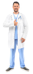 Portrait of male doctor showing thumb-up on white background