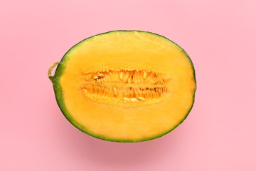 Half of ripe melon on color background