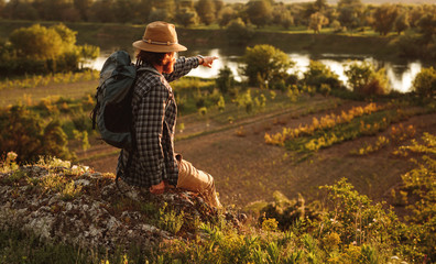Male traveler exploring countryside on sunny day