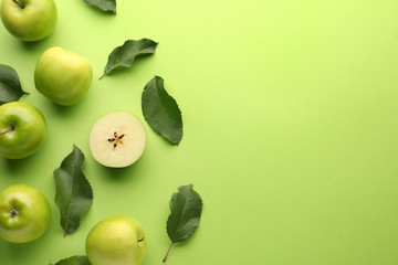 Fresh ripe apples on color background