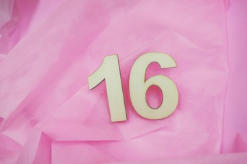 Sweet 16 with number sixteen on pink background