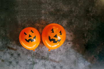 Orange pumpkin balloons for Halloween party on dark background. Happy Halloween. Holiday concept...