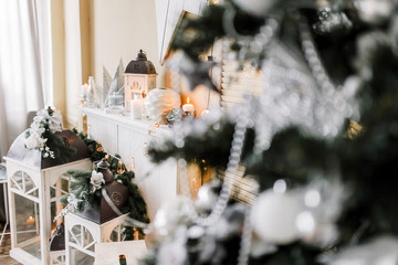 New Year 2020 mood, Christmas tree. Cozy room with fireplace, wardrobe and candlesticks. Merry Christmas.