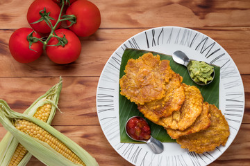 Banana Fritters on a plate, on a wooden table