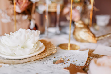 New Year mood. Table with a gold tablecloth, decorated with candles for celebration. Festive still...