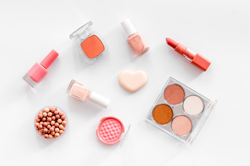 Makeup background with rounge, powder and tools on white table top view