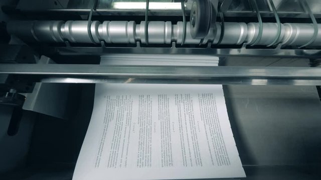 Typographic machine is issuing and relocating printed paper