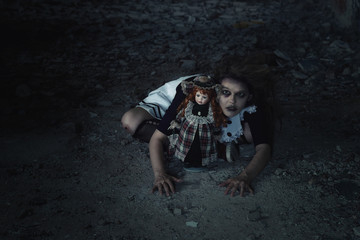 scary girl with a doll in an abandoned house.tinting and noise