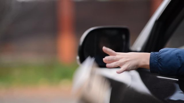 the driver throws out different rubbish from the opened car window, selective focus