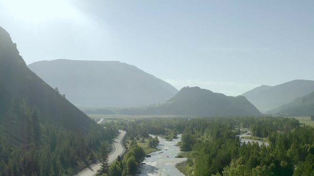 Top Down view of Fast Moving River with Rapids Surrounded by Pine Forest. Shot in Europe