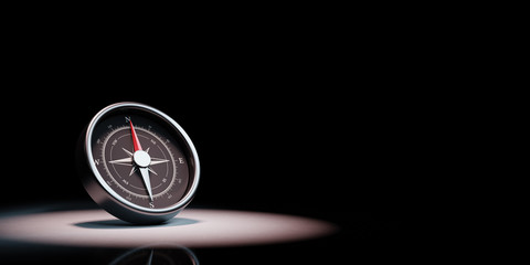 Compass Spotlighted on Black Background