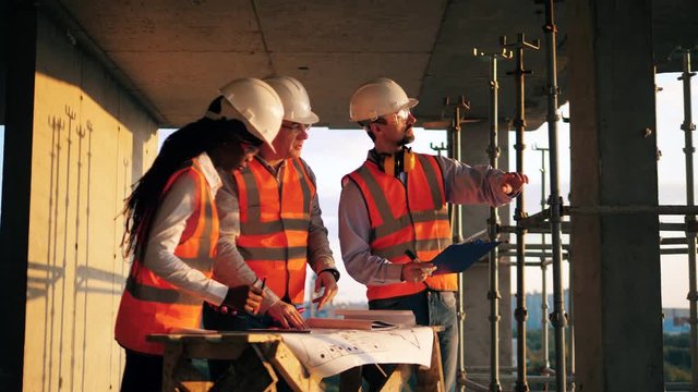 People in uniform work together on a building site.