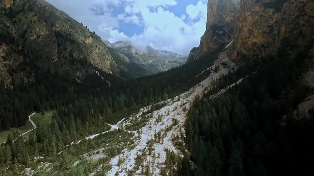 Aerial of a drone flight over an old landslide in Vallunga / Langental in the Italian Alps. Beautiful valley with imposing cliffs.