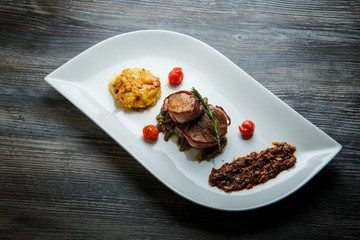 top view on exquisite restaurant dish of roasted meat with sauce