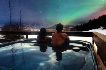 Outdoor kussens Asian couples in the hot tubs of luxury resorts and northern lights, traveling on holiday Iceland, travel ideas © phonix_a