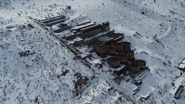 A drone orbits the rusty Old Tintic Mill in Geneloa, Utah, revealing the decaying water tanks, leaching tanks, roasters and crusher built in 1920.