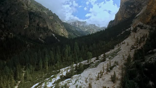 Aerial of a drone flight over an old landslide in Vallunga / Langental in the Dolomites. Beautiful valley with imposing cliffs.