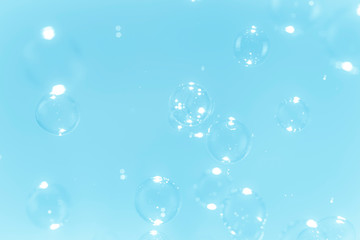 bright soap bubbles float on a blue background
