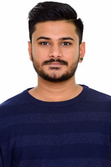 Fototapeta premium Face of young handsome Indian man looking at camera
