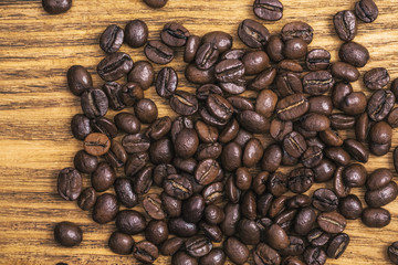 Coffee bean. The background of roasted coffee beans is brown on wooden boards. layout. Flat lay.