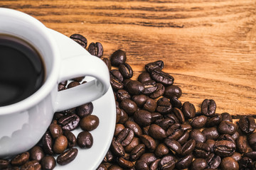 A cup of coffee and scattered coffee beans. Layout. Flat lay. Coffee bean.