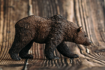 figure of a toy brown bear on a wooden background