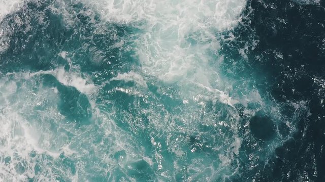 Top view of giant waves splashing and foaming in the ocean